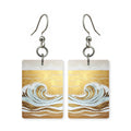 Golden wave earrings — wave curling over in warm gold, cut-paper art, made in USA