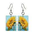Sky sunflower earrings — sunflowers against open blue sky, cut-paper art, made in USA
