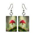 Mossy red cap earrings — red-capped mushroom in deep moss, cut-paper art, made in USA