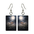 Moonlit monarch earrings — monarch butterfly crossing a full moon, cut-paper art, made in USA