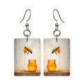 Honey drip bee earrings — bee on a slow drip of honey, cut-paper art, made in USA