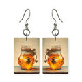 Bee in amber earrings — honey bee suspended in warm amber gold, cut-paper art, made in USA
