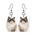 Blue-eyed Ragdoll cat earrings — pointed cat with blue eyes in cut-paper portrait, made in USA