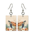 Shallows turtle earrings — sea turtle in bright shallow water, cut-paper art, made in USA