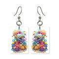 Coral garden turtle earrings — sea turtle over bright coral, cut-paper art, made in USA