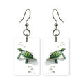 Green sea turtle earrings — sea turtle mid-glide in cut-paper art, made in USA