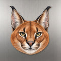 Caracal face wood magnet, shown on stainless steel.