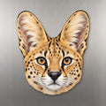 Serval face wood magnet, shown on stainless steel.