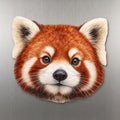 Red Panda face wood magnet, shown on stainless steel.