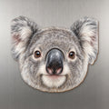 Koala face wood magnet, shown on stainless steel.