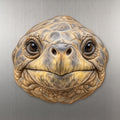Galapagos Tortoise face wood magnet, shown on stainless steel.