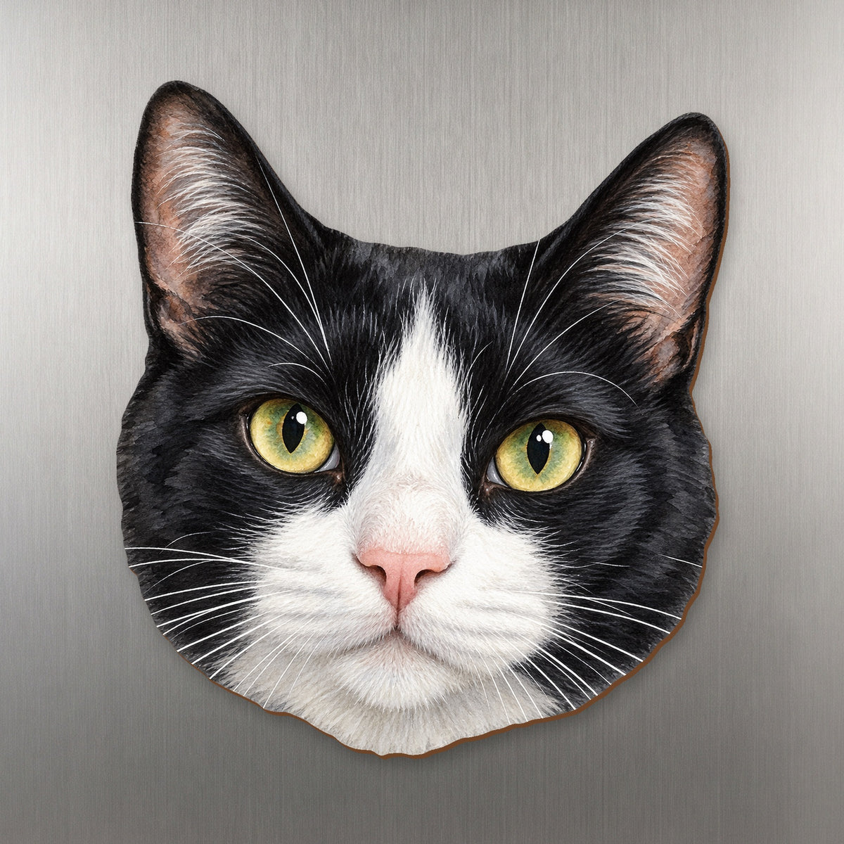 Tuxedo Cat face wood magnet, shown on stainless steel.