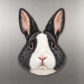 Dutch Rabbit face wood magnet, shown on stainless steel.
