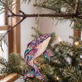 Laser-cut maple wood Gray Whale folk art ornament O100 hanging on a fir branch, made in USA