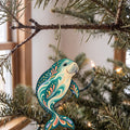 Laser-cut maple wood Dugong folk art ornament O103 hanging on a fir branch, made in USA