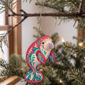 Laser-cut maple wood West Indian Manatee folk art ornament O104 hanging on a fir branch, made in USA