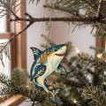 Laser-cut maple wood Great White Shark folk art ornament O106 hanging on a fir branch, made in USA