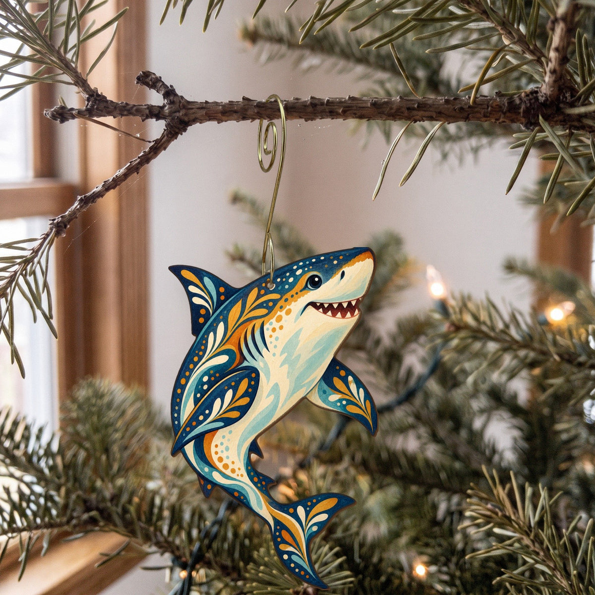 Laser-cut maple wood Great White Shark folk art ornament O106 hanging on a fir branch, made in USA