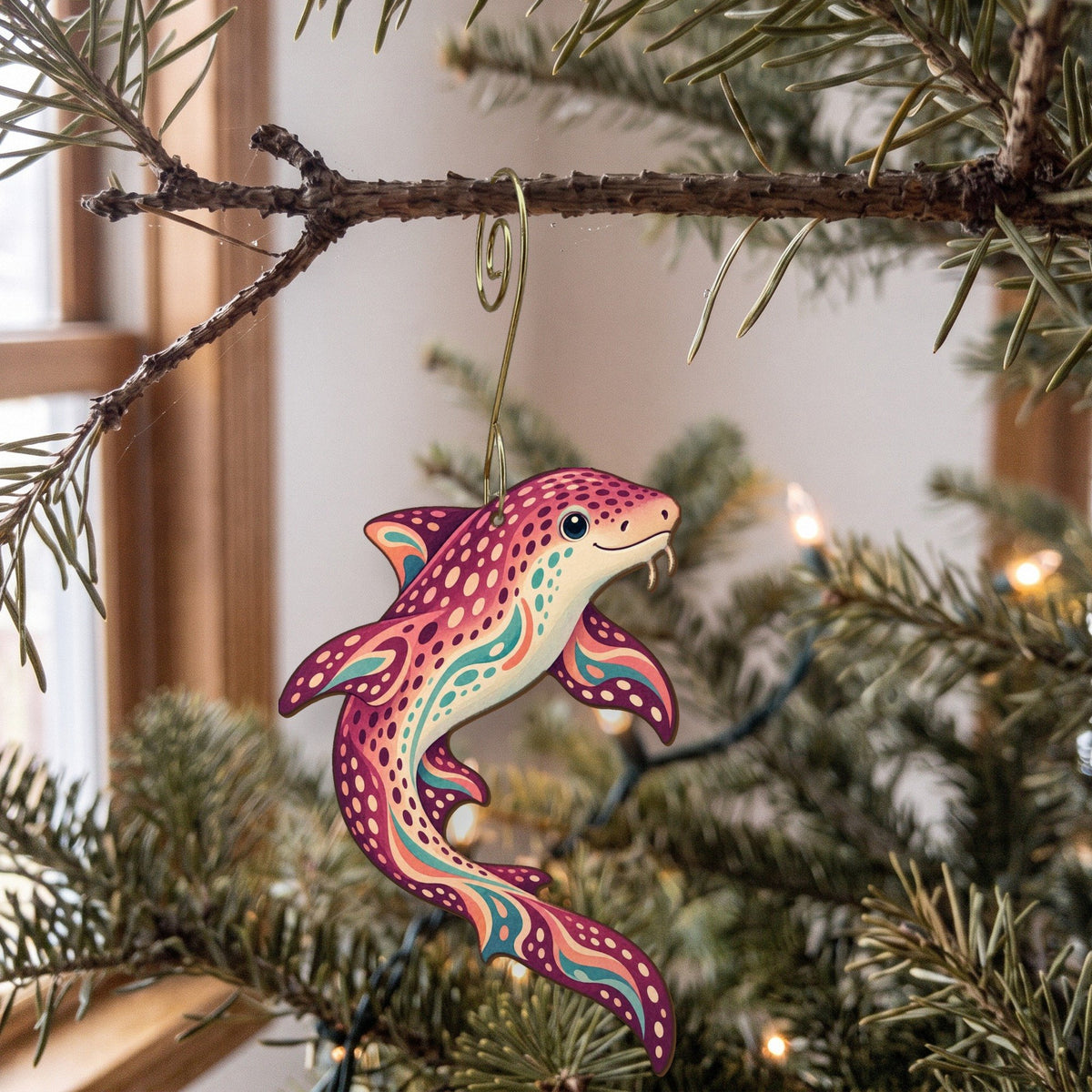 Laser-cut maple wood Zebra Shark folk art ornament O108 hanging on a fir branch, made in USA