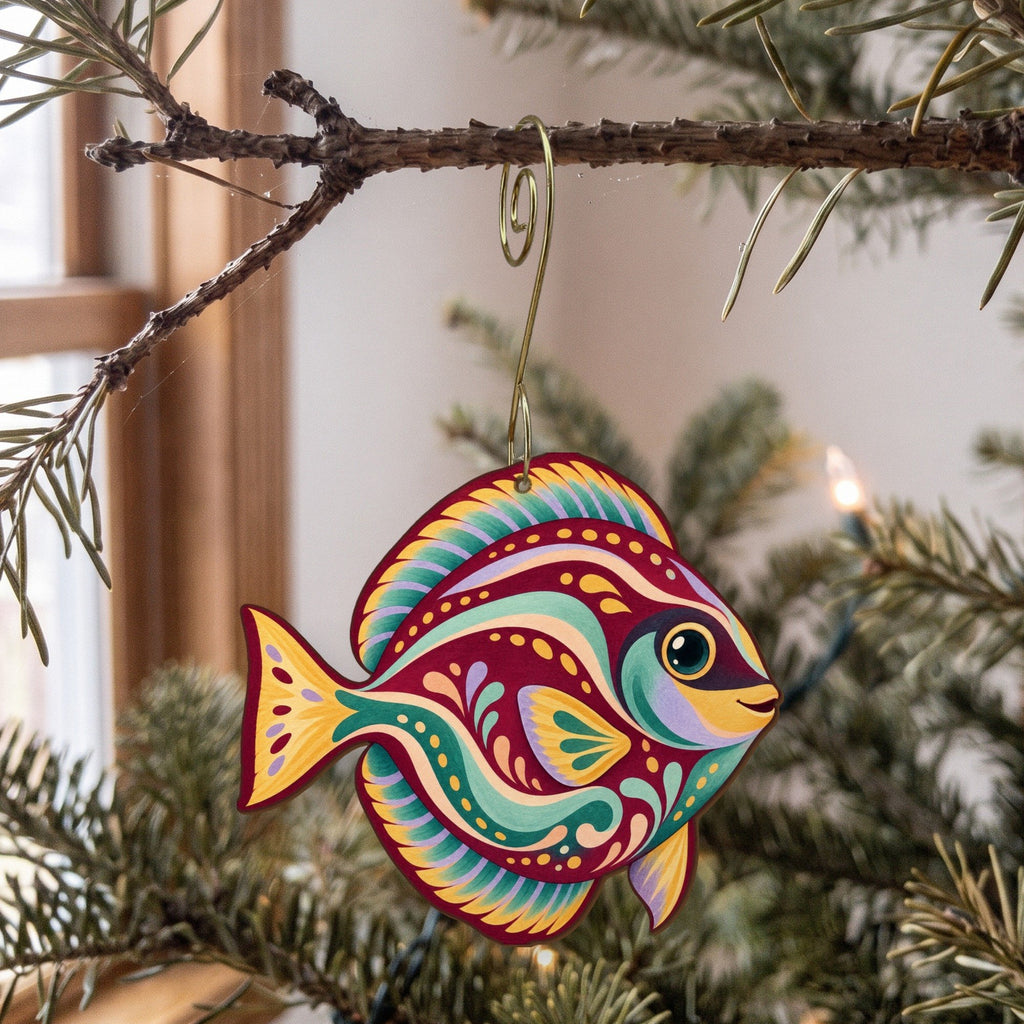 Laser-cut maple wood Blue Tang folk art ornament O118 hanging on a fir branch, made in USA