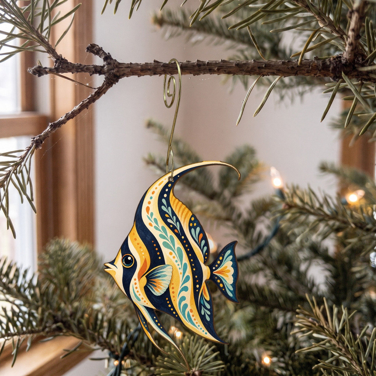 Laser-cut maple wood Moorish Idol folk art ornament O122 hanging on a fir branch, made in USA