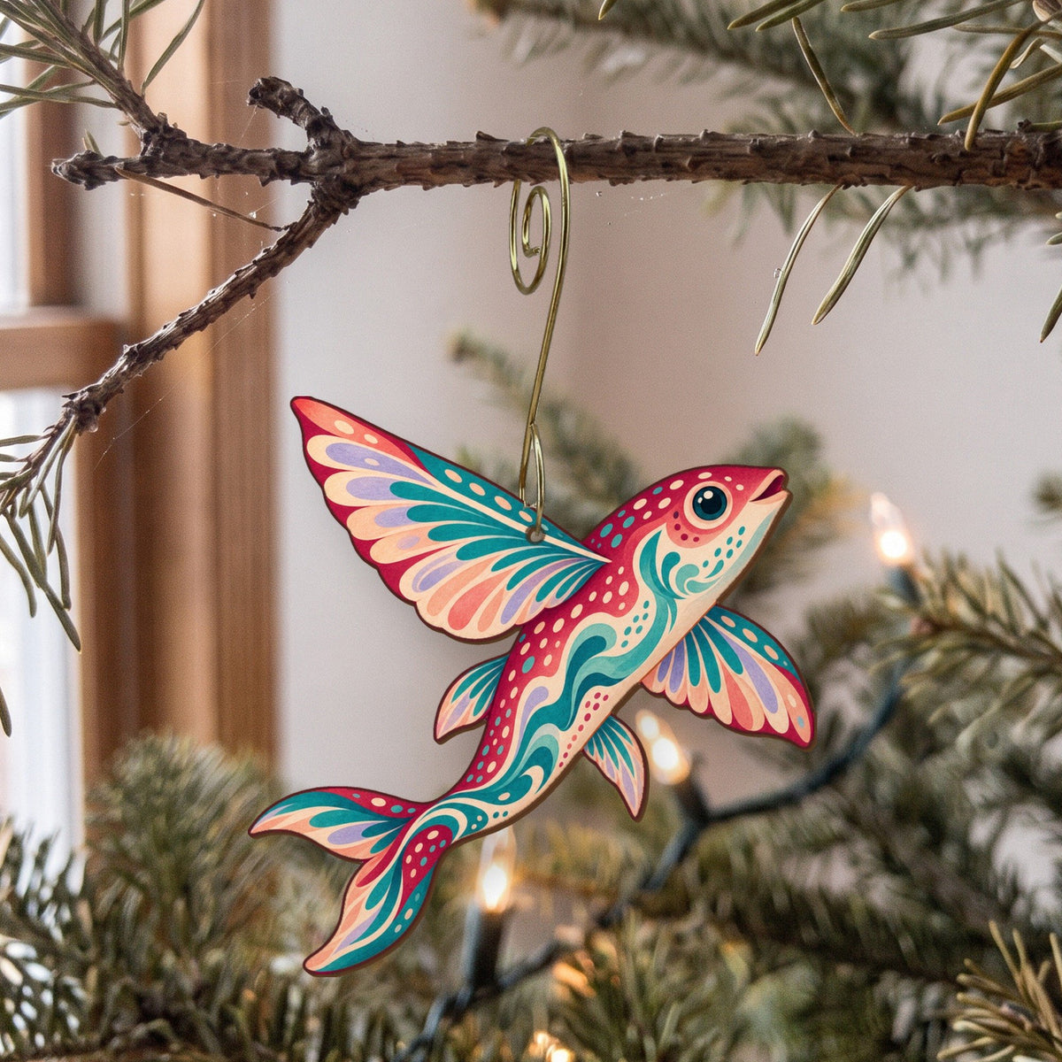Laser-cut maple wood Flying Fish folk art ornament O128 hanging on a fir branch, made in USA