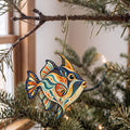 Laser-cut maple wood Triggerfish folk art ornament O130 hanging on a fir branch, made in USA