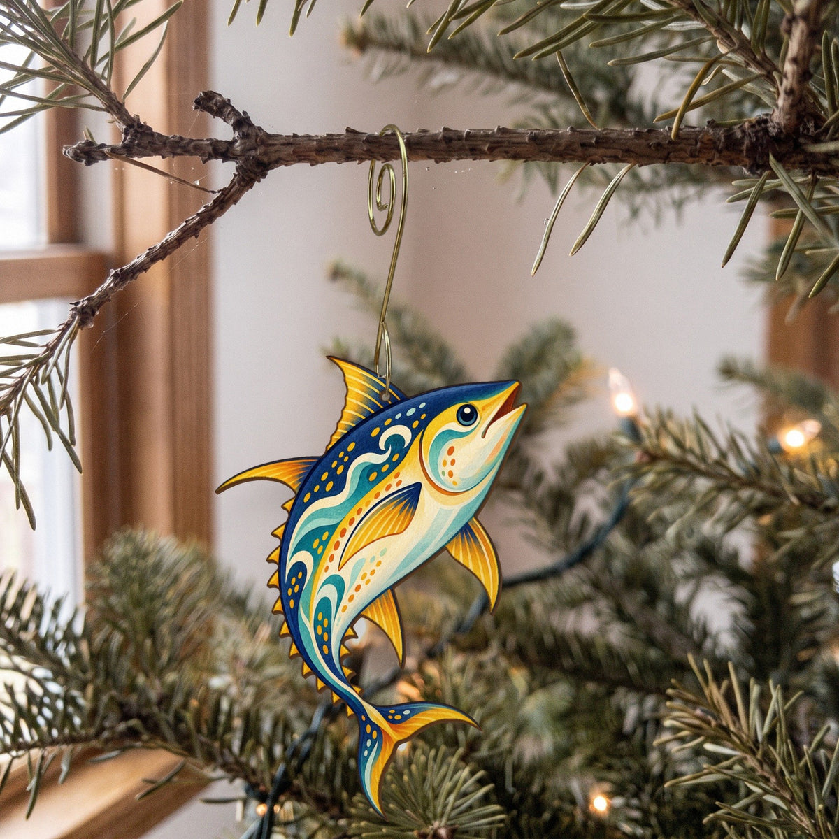 Laser-cut maple wood Yellowfin Tuna folk art ornament O138 hanging on a fir branch, made in USA