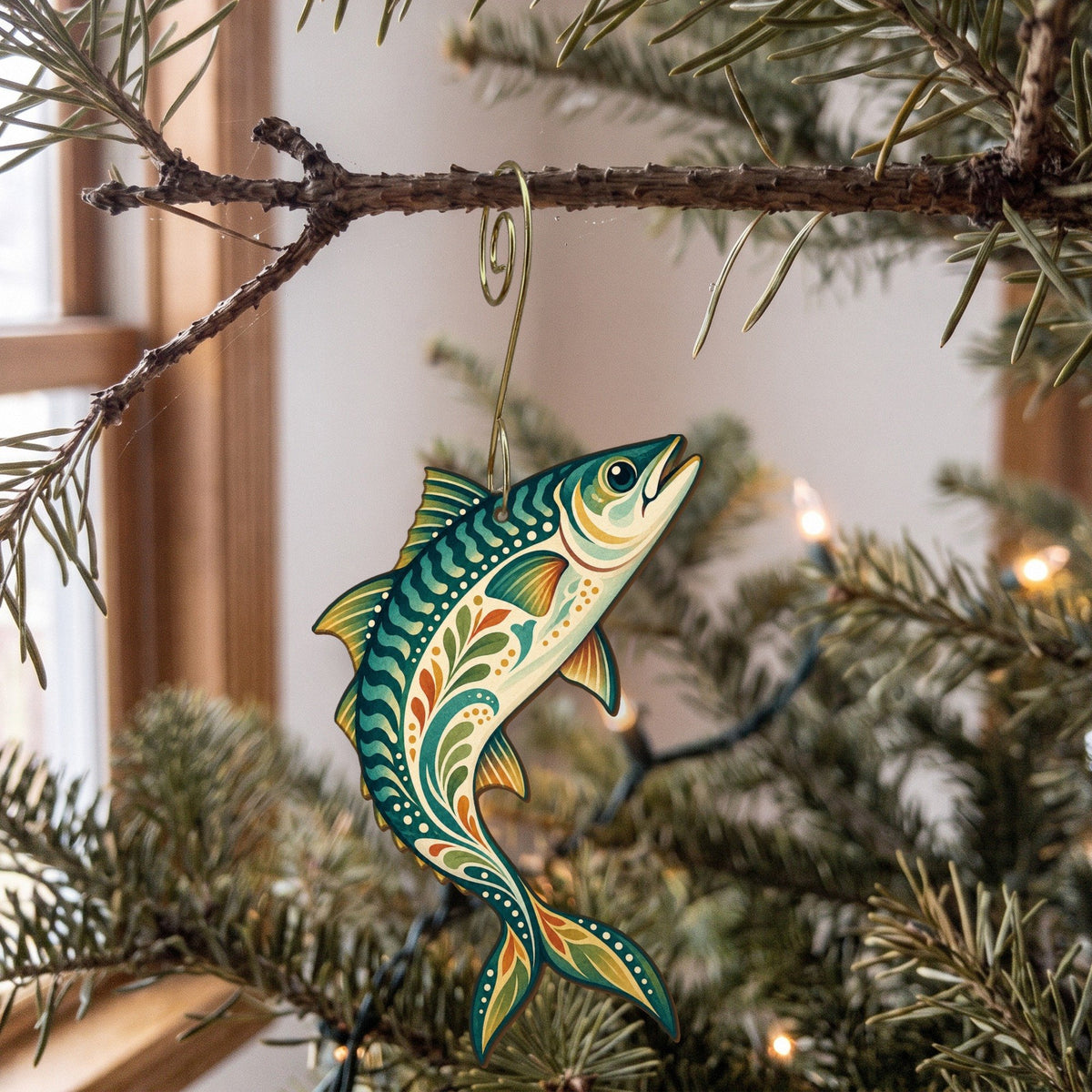 Laser-cut maple wood Atlantic Mackerel folk art ornament O139 hanging on a fir branch, made in USA