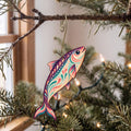 Laser-cut maple wood Sardine folk art ornament O140 hanging on a fir branch, made in USA