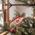 Laser-cut maple wood Atlantic Cod folk art ornament O142 hanging on a fir branch, made in USA