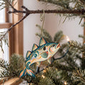 Laser-cut maple wood Haddock folk art ornament O143 hanging on a fir branch, made in USA