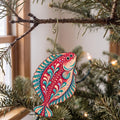 Laser-cut maple wood Halibut folk art ornament O144 hanging on a fir branch, made in USA