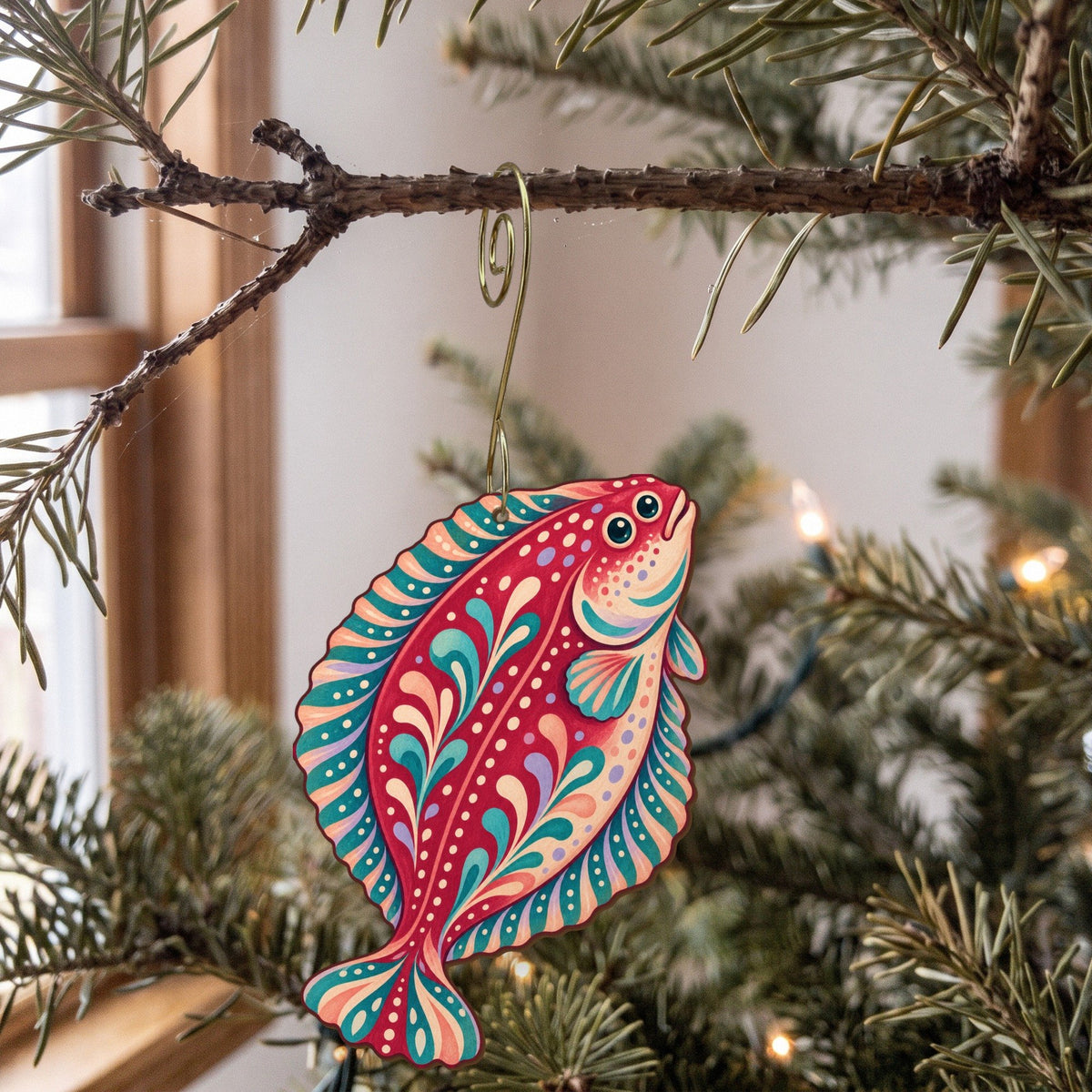 Laser-cut maple wood Halibut folk art ornament O144 hanging on a fir branch, made in USA
