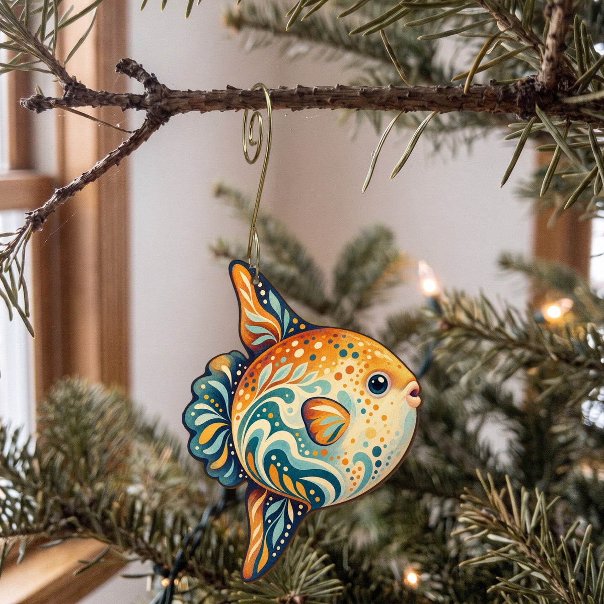 Laser-cut maple wood Ocean Sunfish folk art ornament O146 hanging on a fir branch, made in USA