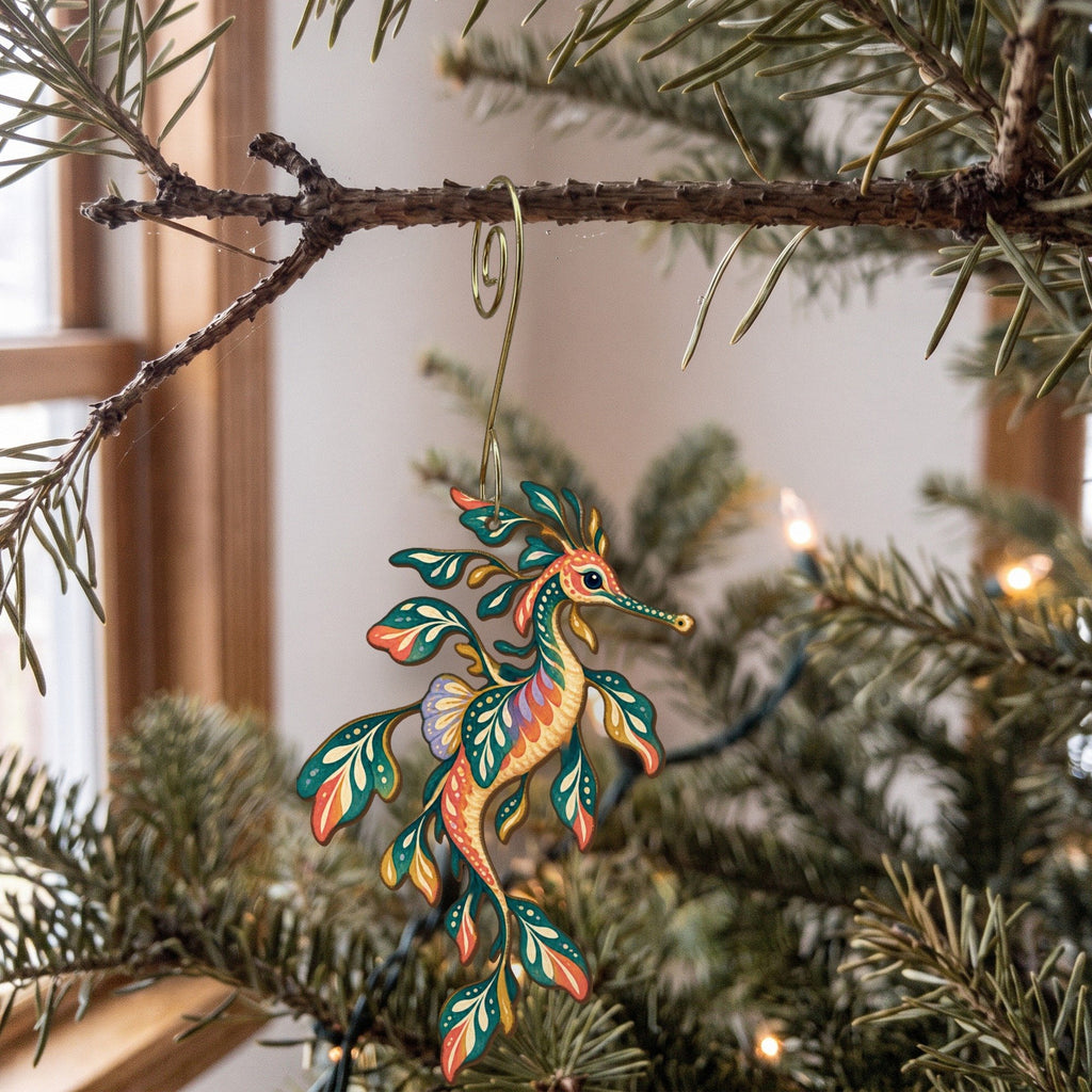 Laser-cut maple wood Weedy Seadragon folk art ornament O151 hanging on a fir branch, made in USA