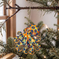 Laser-cut maple wood Blue-Ringed Octopus folk art ornament O154 hanging on a fir branch, made in USA
