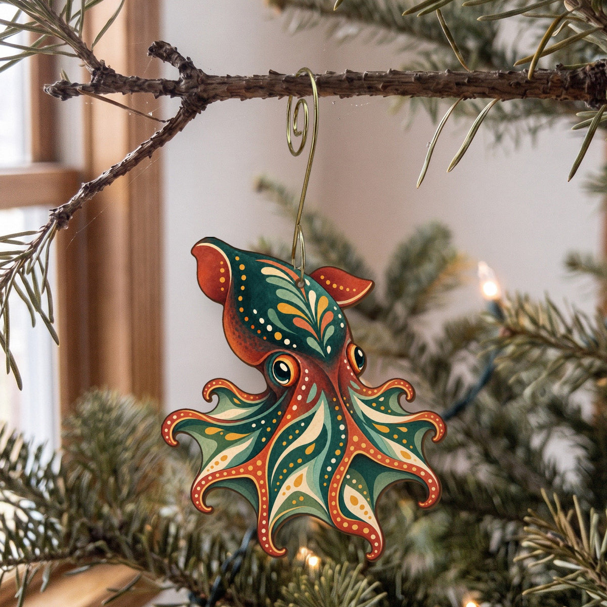 Laser-cut maple wood Vampire Squid folk art ornament O155 hanging on a fir branch, made in USA