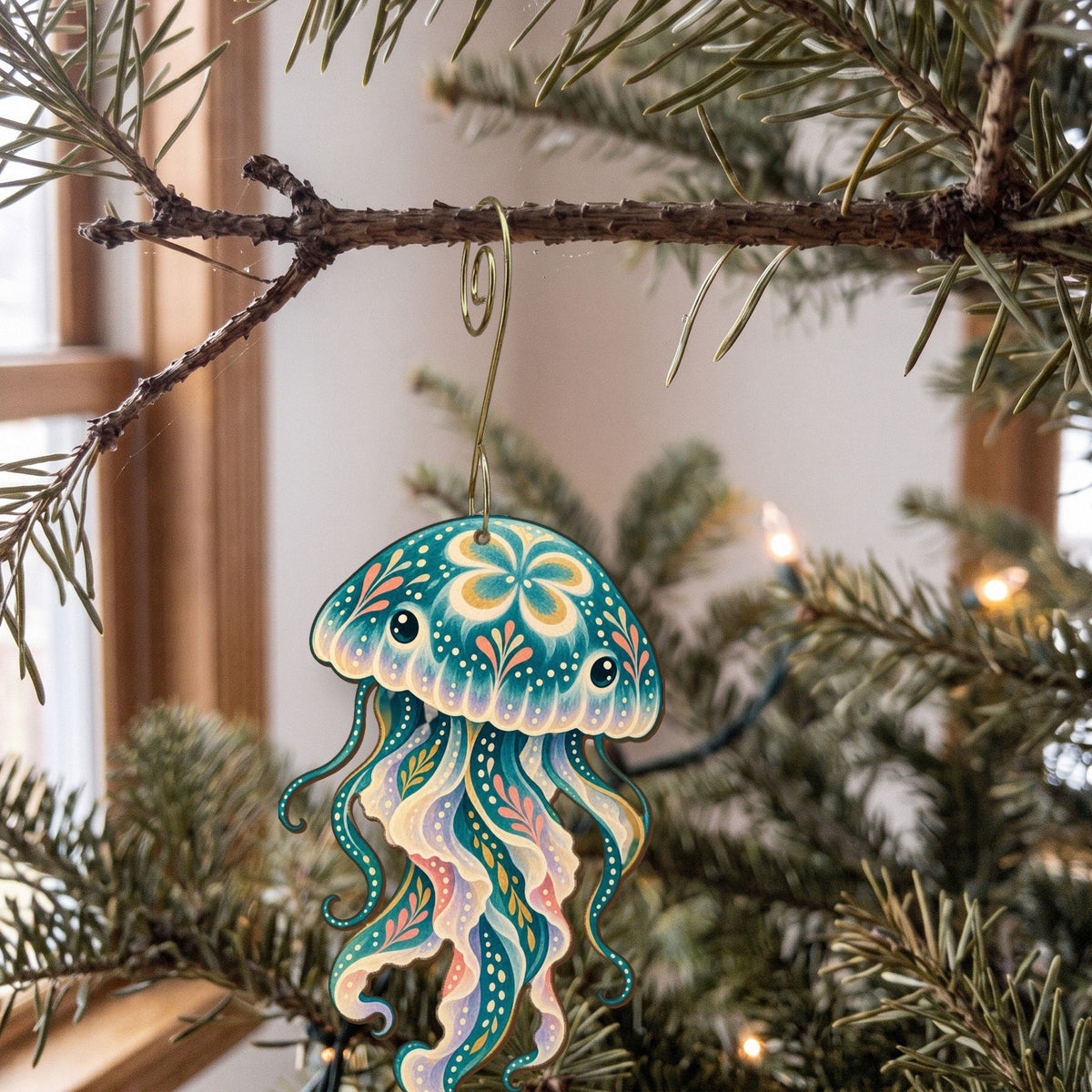 Laser-cut maple wood Moon Jellyfish folk art ornament O159 hanging on a fir branch, made in USA