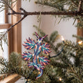 Laser-cut maple wood Blue Dragon Sea Slug folk art ornament O164 hanging on a fir branch, made in USA