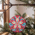 Laser-cut maple wood Sand Dollar folk art ornament O168 hanging on a fir branch, made in USA