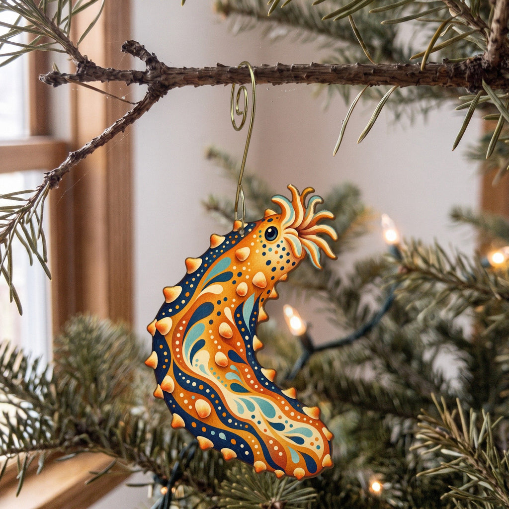 Laser-cut maple wood Sea Cucumber folk art ornament O170 hanging on a fir branch, made in USA