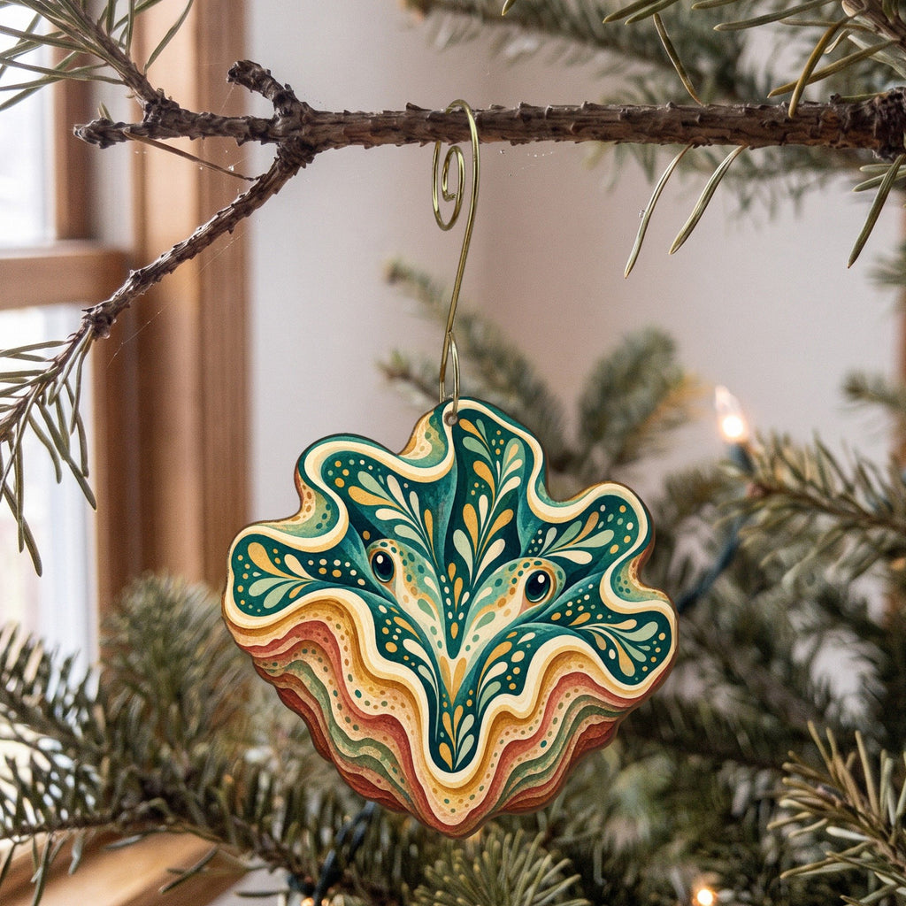 Laser-cut maple wood Giant Clam folk art ornament O171 hanging on a fir branch, made in USA