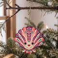 Laser-cut maple wood Scallop folk art ornament O172 hanging on a fir branch, made in USA