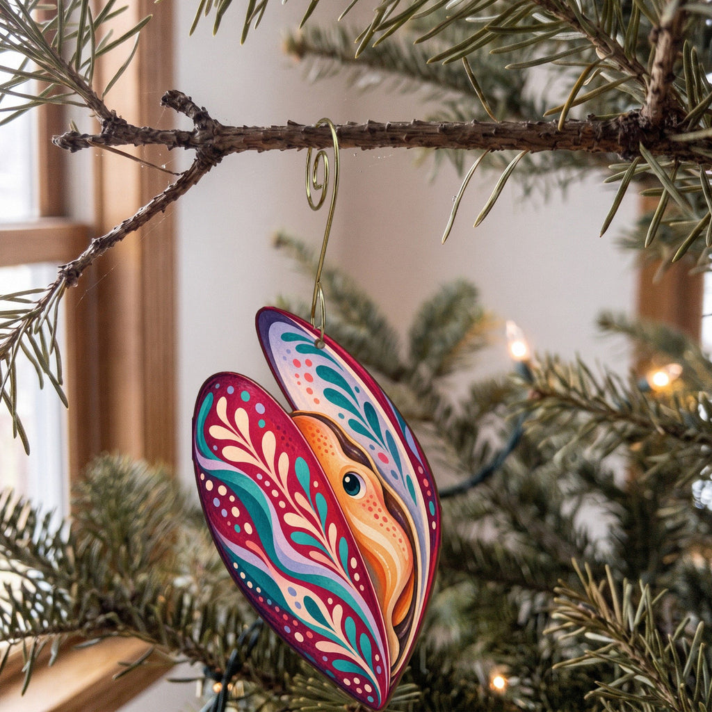 Laser-cut maple wood Mussel folk art ornament O176 hanging on a fir branch, made in USA