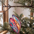 Laser-cut maple wood Mussel folk art ornament O176 hanging on a fir branch, made in USA