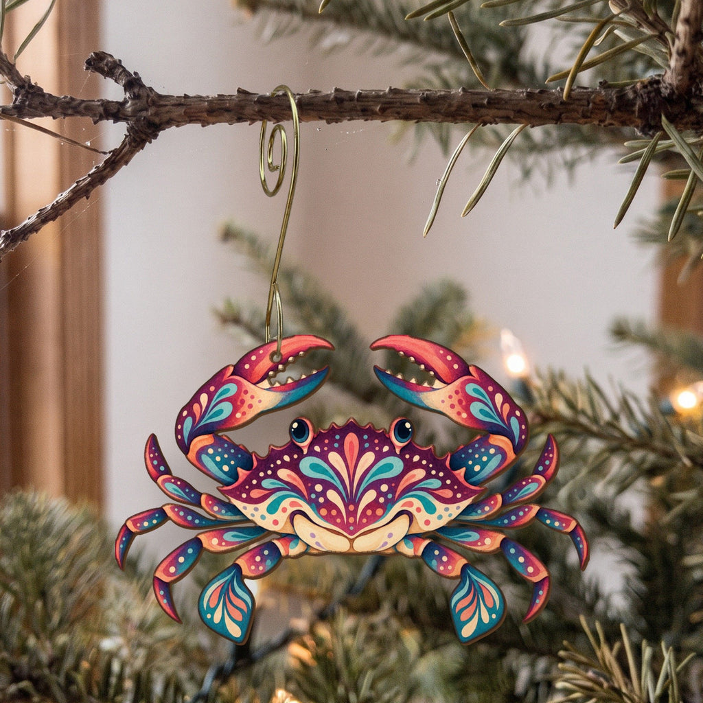Laser-cut maple wood Blue Crab folk art ornament O180 hanging on a fir branch, made in USA