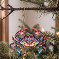 Laser-cut maple wood Blue Crab folk art ornament O180 hanging on a fir branch, made in USA