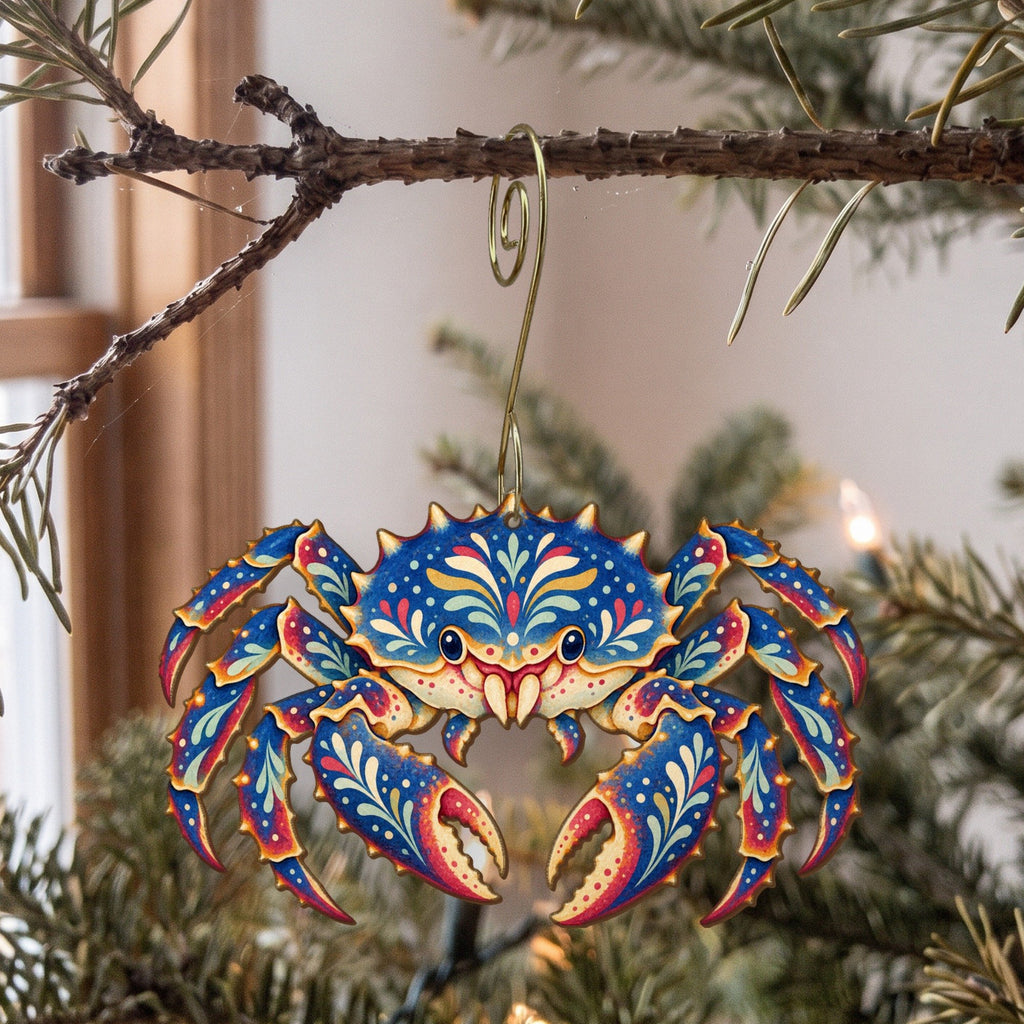 Laser-cut maple wood King Crab folk art ornament O181 hanging on a fir branch, made in USA