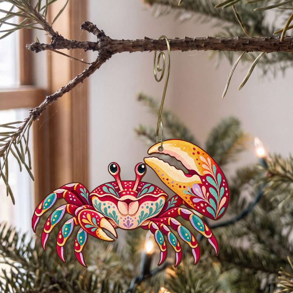 Laser-cut maple wood Fiddler Crab folk art ornament O182 hanging on a fir branch, made in USA